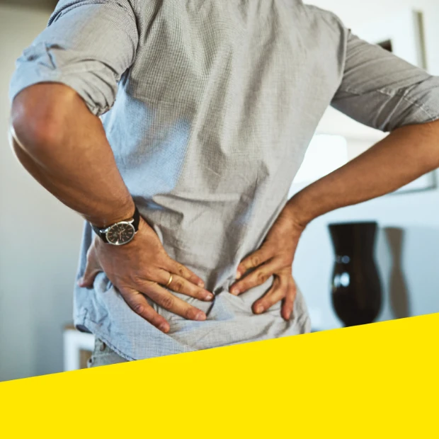 A woman rubs cream into her shoulder.
