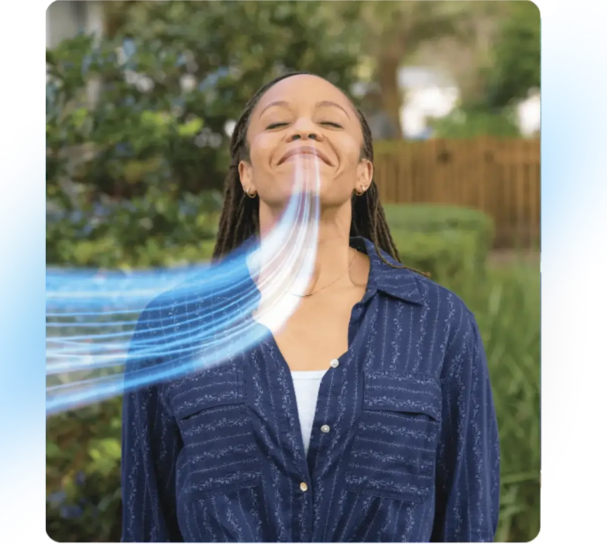 A woman breathes in deeply through her nose.