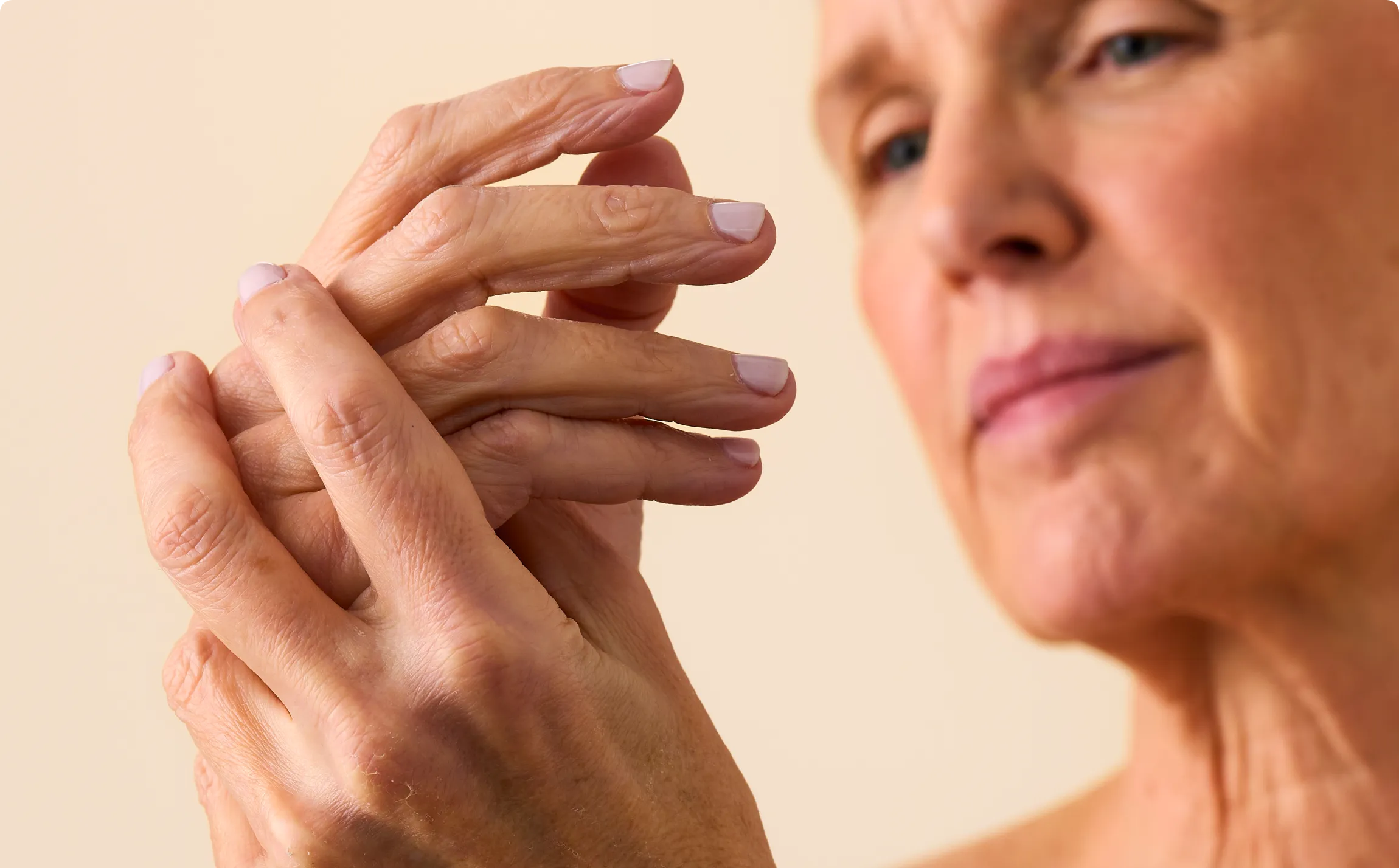 Close-up of a woman's arm featuring natural skin texture and lines. 