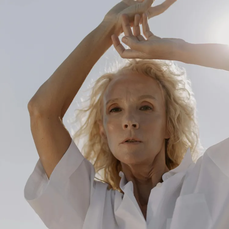 Close-up of a woman's back with natural skin, displaying signs of thinness and dehydration.