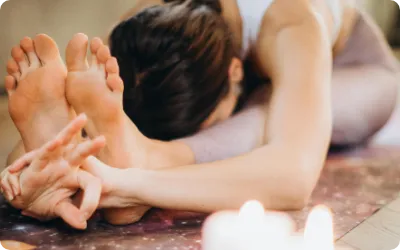 A close-up of a person's feet while they stretch and highlighting the moisture and odor control category.