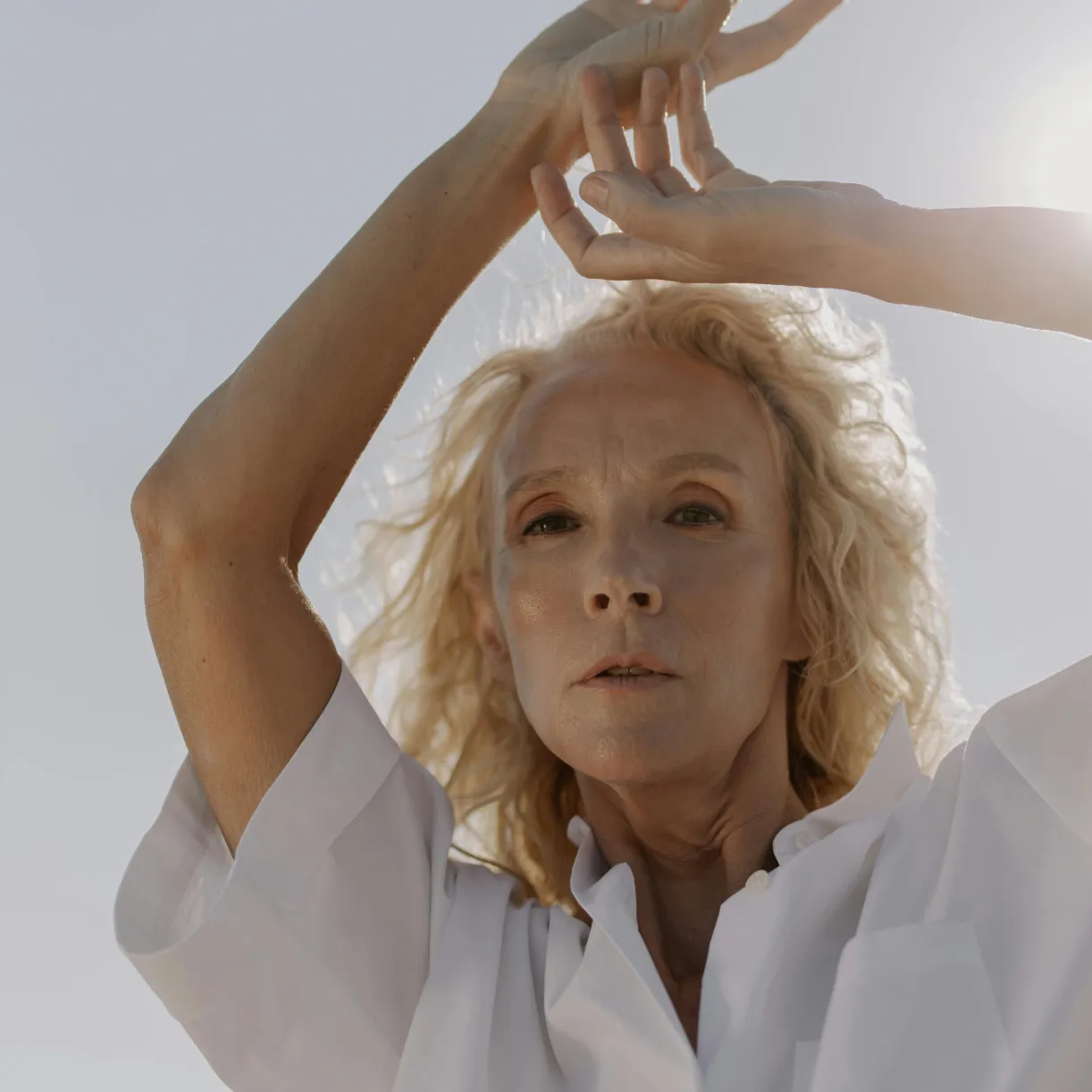 Close-up of a woman's back with natural skin, displaying signs of thinness and dehydration.