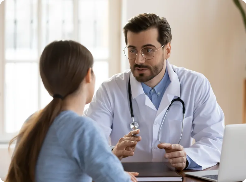a woman speaks with her doctor.