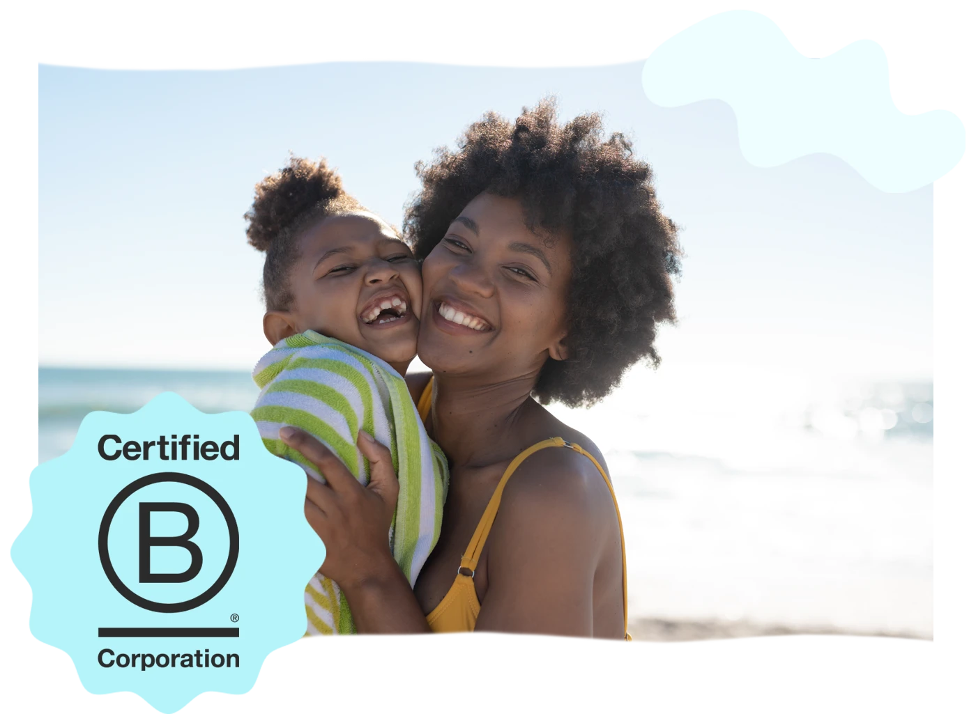 Cheerful African American mother and daughter share a moment at the sunny beach, cheek to cheek. In the lower-left corner, a black B-Corp Certified logo is visible.