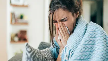 a woman with allergy symptoms in an outdoor setting 