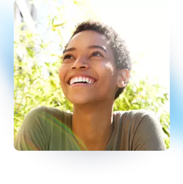 A woman breathes in deeply through her nose.